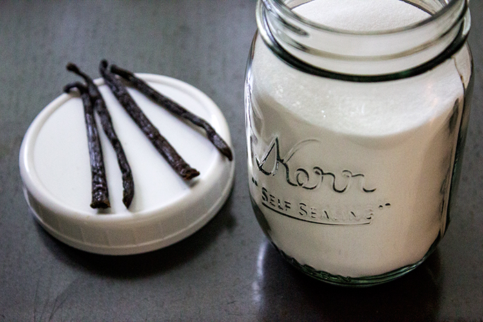 Cut Vanilla Beans and a Jar of Sugar